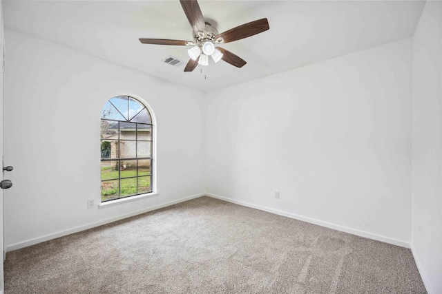 carpeted spare room with ceiling fan