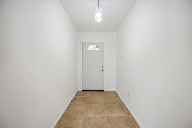 doorway with light tile patterned flooring