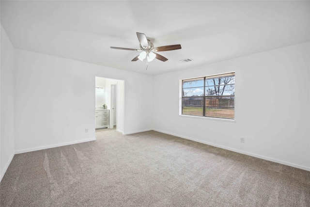 carpeted spare room with ceiling fan