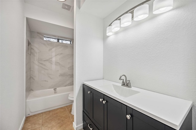 full bathroom featuring vanity, tiled shower / bath, tile patterned floors, and toilet