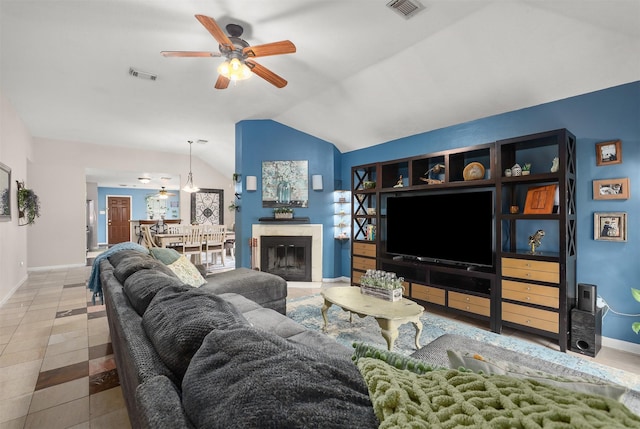 tiled living room featuring ceiling fan and lofted ceiling