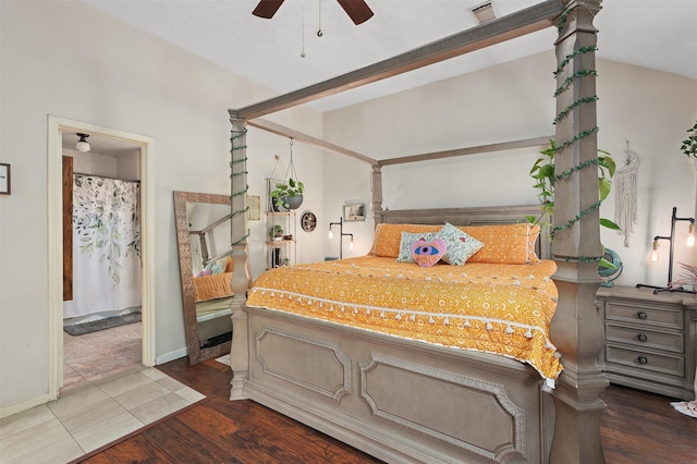 bedroom with lofted ceiling, dark hardwood / wood-style floors, and ensuite bathroom