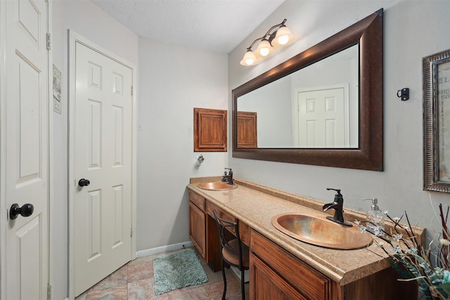 bathroom with vanity and a textured ceiling