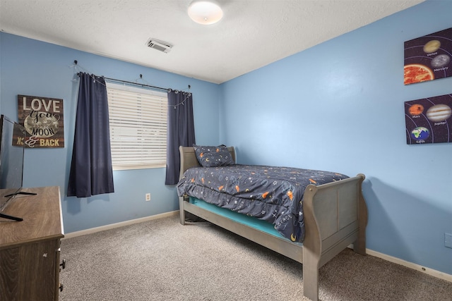 carpeted bedroom with a textured ceiling