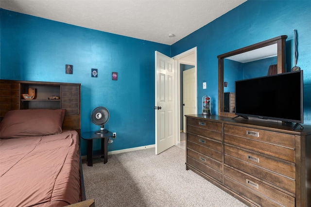 bedroom with light carpet and a textured ceiling