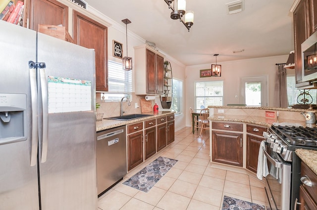 kitchen with sink, stainless steel appliances, ornamental molding, decorative backsplash, and decorative light fixtures