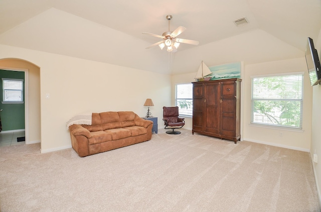 living area with ceiling fan, light colored carpet, and vaulted ceiling