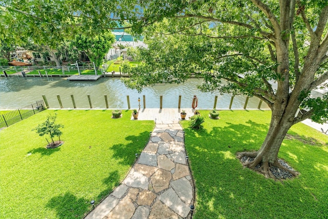 view of yard with a water view and a boat dock