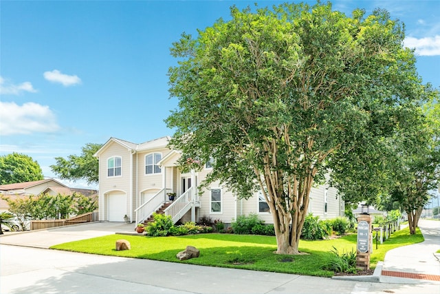 view of front of property featuring a garage and a front yard