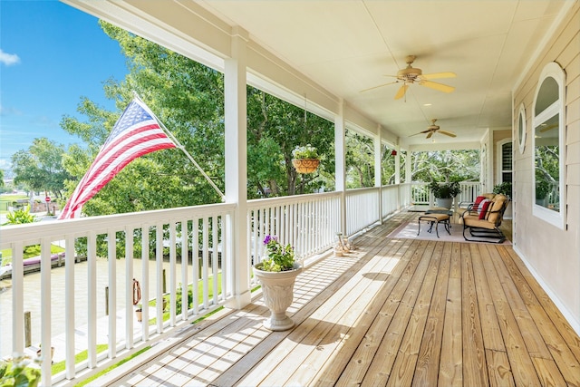 wooden terrace featuring a porch and ceiling fan