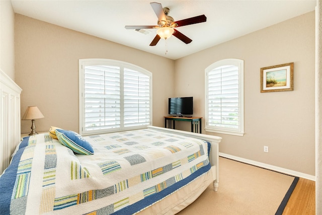 bedroom featuring multiple windows, ceiling fan, and light hardwood / wood-style floors