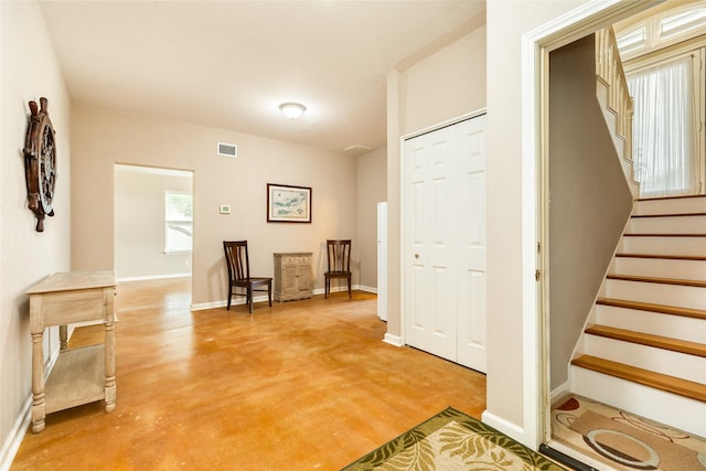 hall featuring concrete flooring