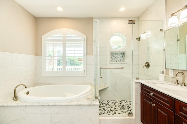 bathroom featuring vanity and shower with separate bathtub