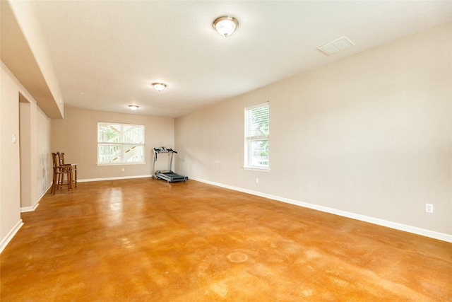 spare room with concrete flooring and plenty of natural light