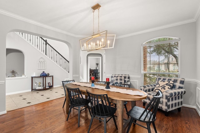 dining space with wood-type flooring and crown molding