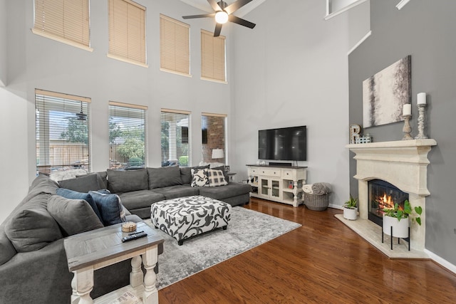 living room featuring dark hardwood / wood-style floors and ceiling fan