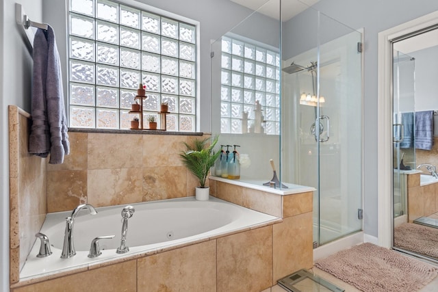 bathroom with tile patterned floors, a healthy amount of sunlight, and plus walk in shower