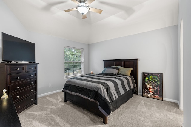 bedroom with vaulted ceiling, light colored carpet, and ceiling fan