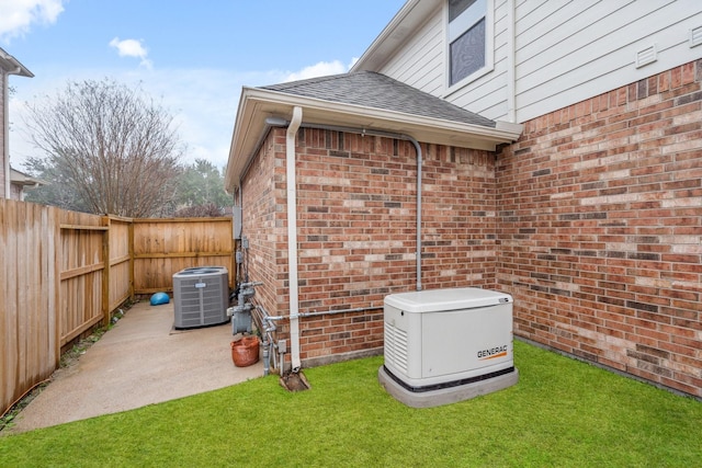 view of outdoor structure with a yard and central air condition unit