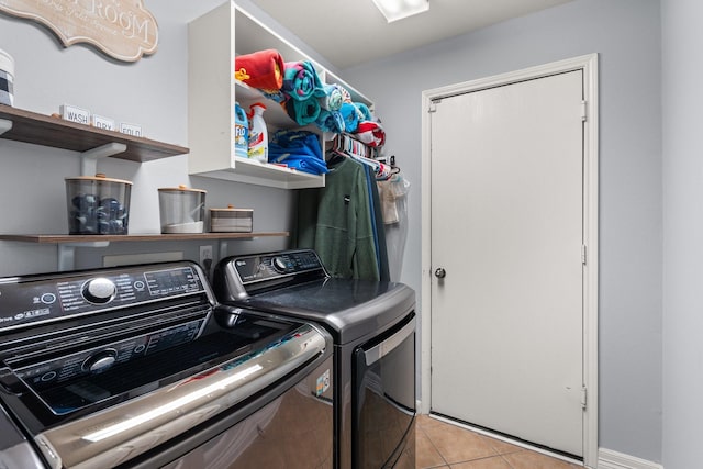 laundry room featuring light tile patterned flooring and washer and dryer