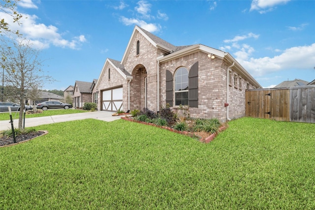 view of front of house featuring a garage and a front lawn