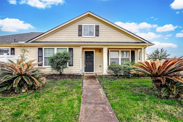 bungalow-style home featuring a front yard