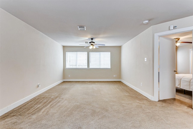 carpeted empty room with ceiling fan