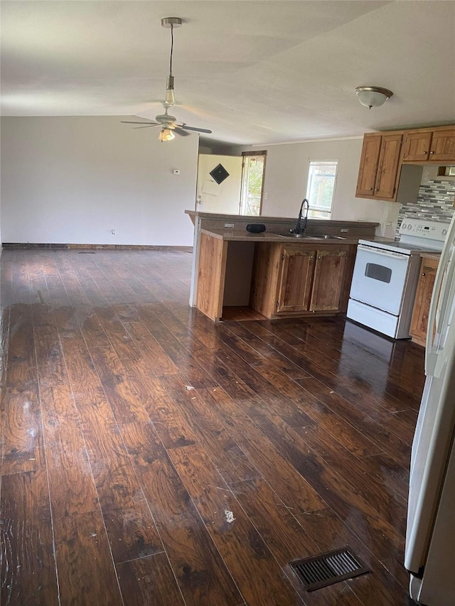 kitchen with white appliances, dark hardwood / wood-style flooring, and sink