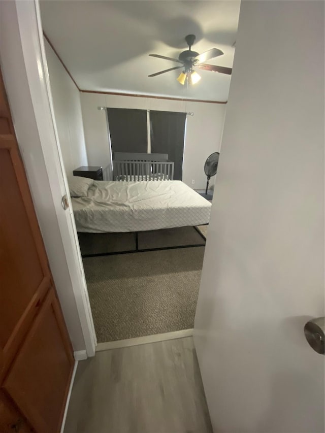 bedroom with ceiling fan and wood-type flooring