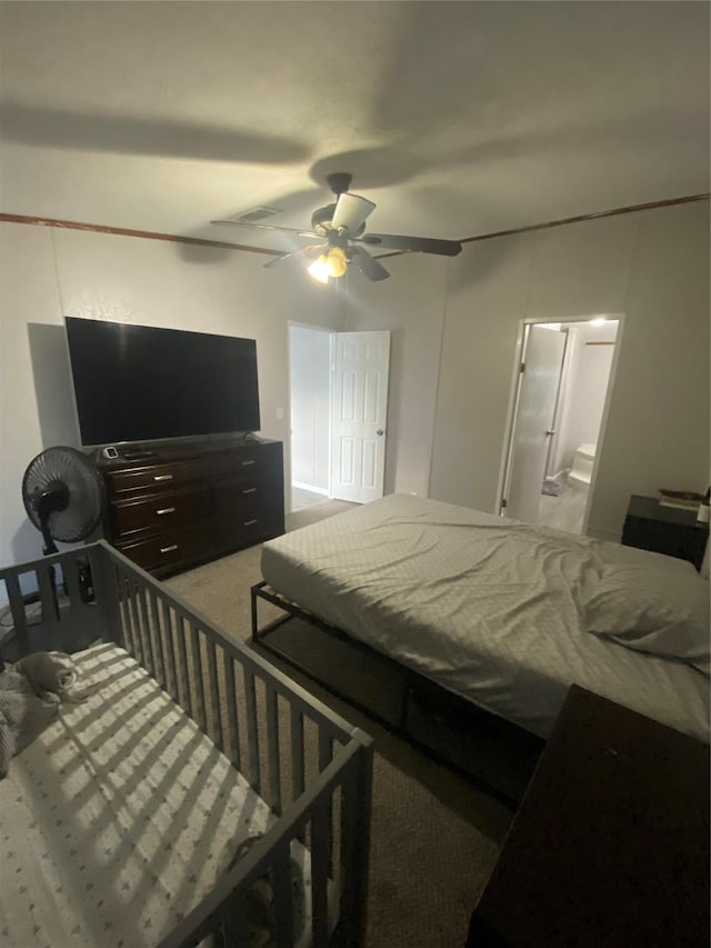 bedroom featuring ceiling fan, connected bathroom, and carpet flooring