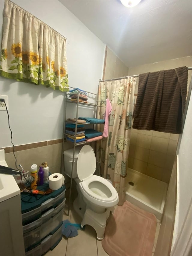 bathroom with tile walls, tile patterned flooring, vanity, toilet, and a shower with curtain