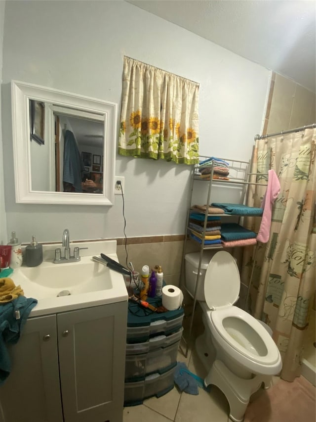 bathroom featuring toilet, a shower with curtain, tile walls, vanity, and tile patterned flooring