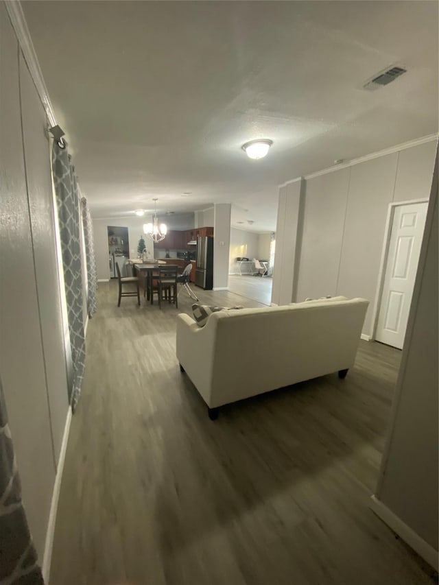 living room featuring a notable chandelier and wood-type flooring