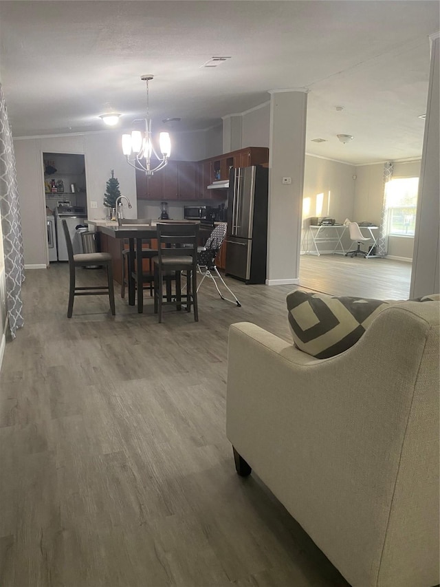 dining area with a notable chandelier and light hardwood / wood-style flooring