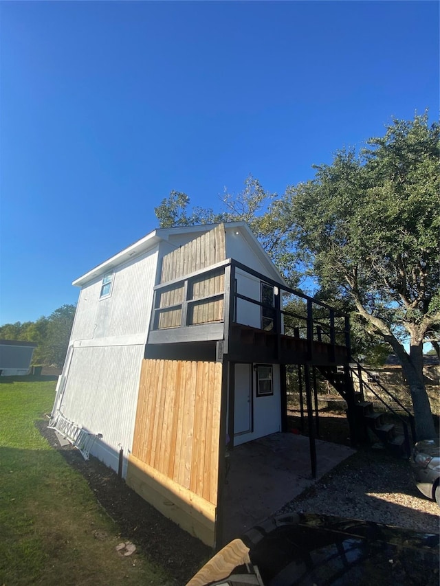 view of property exterior with a wooden deck