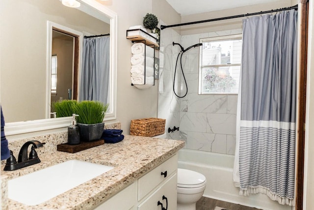 full bathroom with vanity, toilet, and shower / tub combo