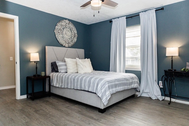 bedroom featuring ceiling fan and hardwood / wood-style floors