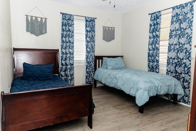 bedroom with hardwood / wood-style flooring and a textured ceiling