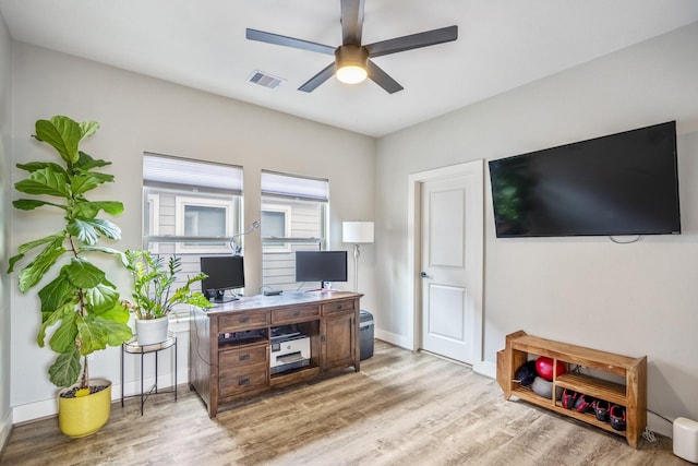 office with ceiling fan and light hardwood / wood-style flooring