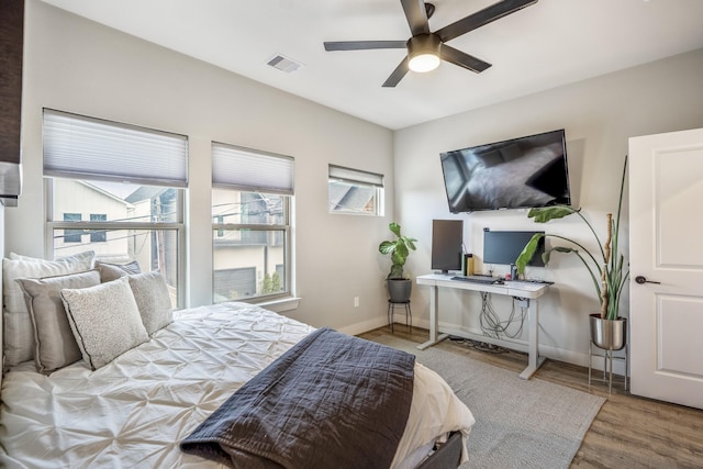 bedroom with hardwood / wood-style flooring and ceiling fan