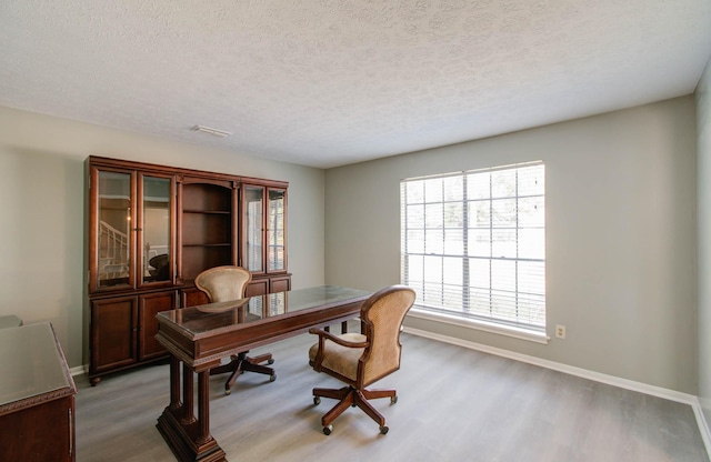 office space featuring hardwood / wood-style flooring and a textured ceiling