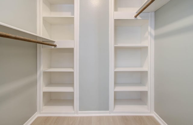 spacious closet featuring light hardwood / wood-style flooring