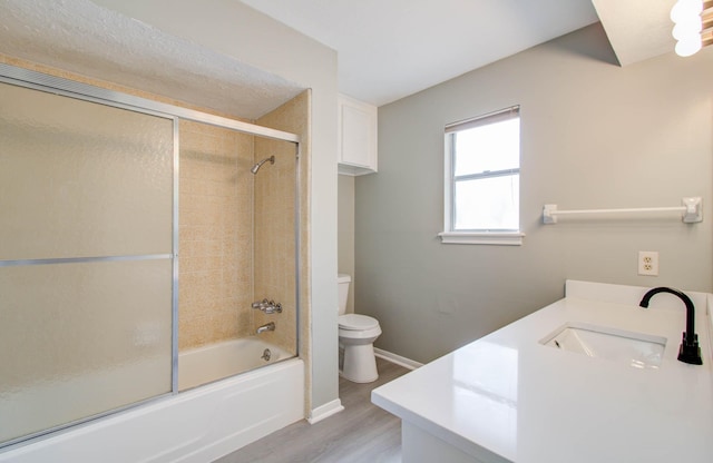 full bathroom with shower / bath combination with glass door, vanity, toilet, and wood-type flooring