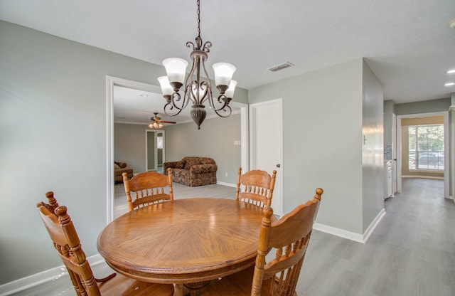 dining area with a notable chandelier and light wood-type flooring