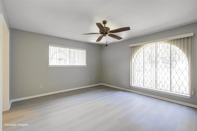 spare room with light hardwood / wood-style flooring and ceiling fan