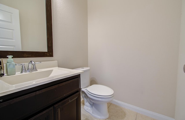 bathroom featuring tile patterned flooring, vanity, and toilet