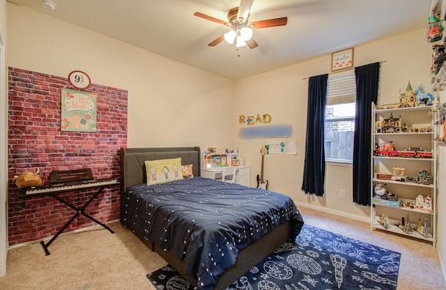 bedroom with light carpet, ceiling fan, and brick wall