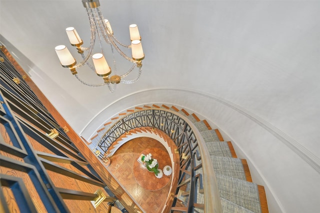 stairs with a chandelier