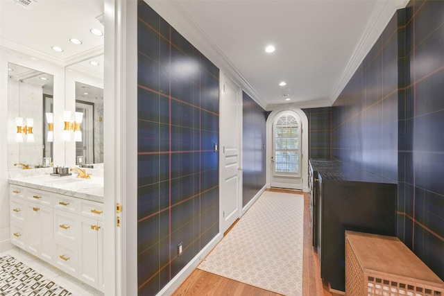 bathroom with vanity, wood-type flooring, and ornamental molding