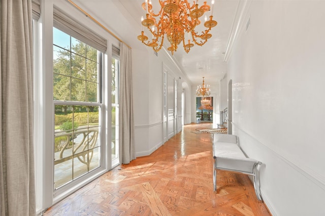 hallway featuring baseboards and an inviting chandelier